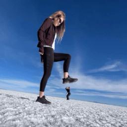 Female stomping down on a figure perspective photo on the Uyuni Salt Flat